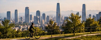 Cyclists and green space with a city skyline