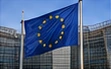 A European Union flag in front of an office building